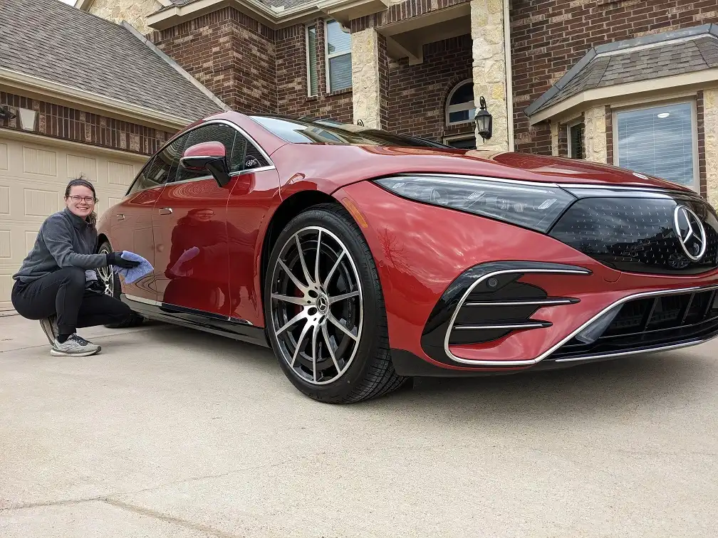 nitro mobile detailing employee with a red Mercedes after it received a wash and wax car detail service mansfield